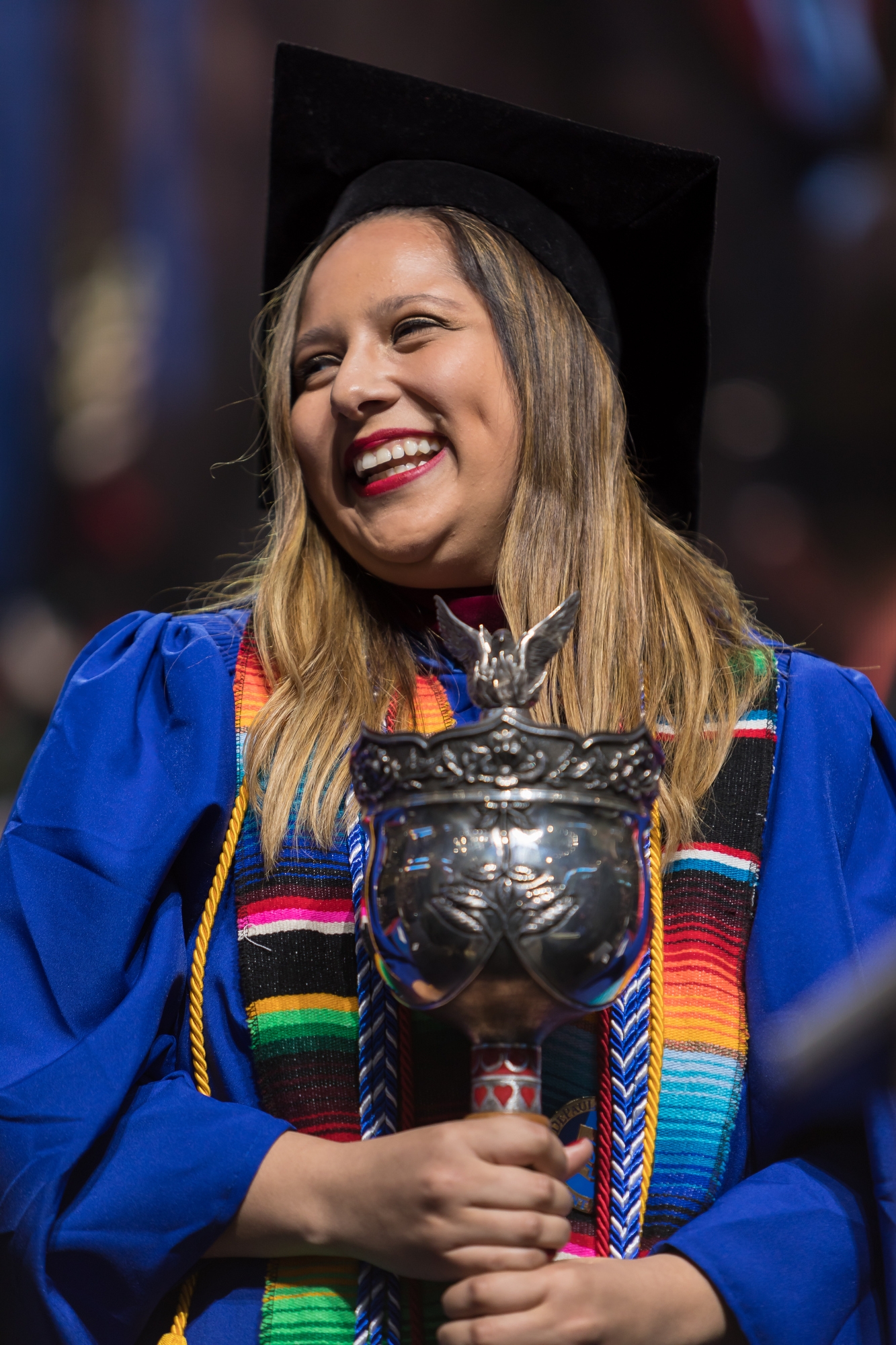 Graciela Covarrubias leads the procession with the university mace to begin the commencement ceremony for the College of Communication and the College of Computing and Digital Media. (DePaul University/Jeff Carrion)